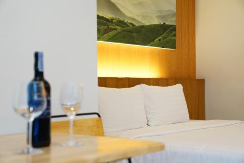a bottle of wine sitting on a table with a wine glass at 130 Hotel & Residence Bangkok in Bangkok