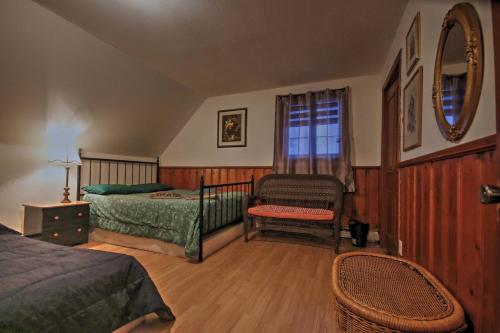 a bedroom with two beds and a chair and a window at Vieille Maison Rustique Espace Intéressant in Quebec City