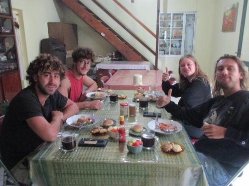 a group of people sitting around a table eating food at MJR Ticketing Guest House in Ruteng