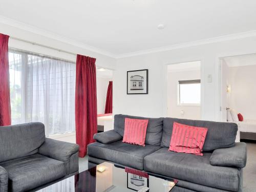 a living room with a couch and a table at Matamata Central Motel in Matamata