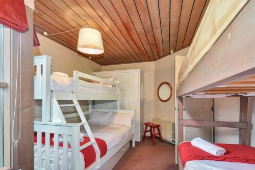 a bedroom with two bunk beds and a desk at Snowgums 06 in Dinner Plain