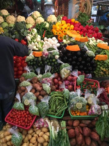a display of fruits and vegetables in a market at Tradewinds Lodge in Diani Beach