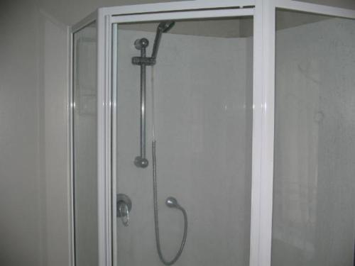 a shower in a bathroom with a glass door at The House in Christchurch