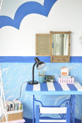 a blue table with a lamp on top of it at Happiness Factory in Huxi