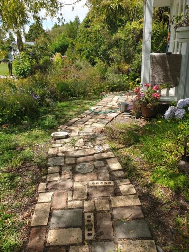a stone path in front of a house at Cabins on Tudor bed & breakfast in Motueka