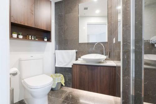 a bathroom with a toilet and a sink at Lvl 57 Skytower Breathtaking Views CBD Wifi Carpark by Stylish Stays in Brisbane