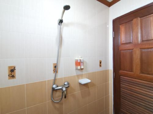 a shower in a bathroom next to a door at Praew Mansion in Kamala Beach