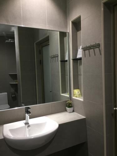 a bathroom with a sink and a mirror at Meriton Inn in Kuantan