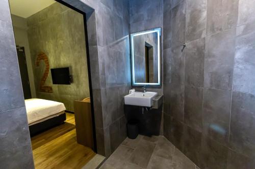 a bathroom with a sink and a mirror at Brown Hotel in George Town