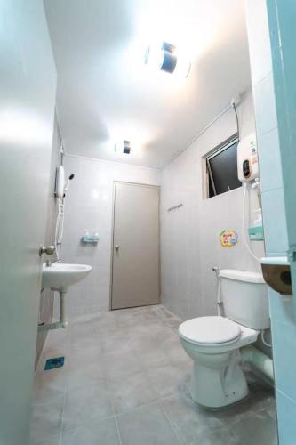 a bathroom with a toilet and a sink at Star Light Homestay 19@ The Venus in Sitiawan