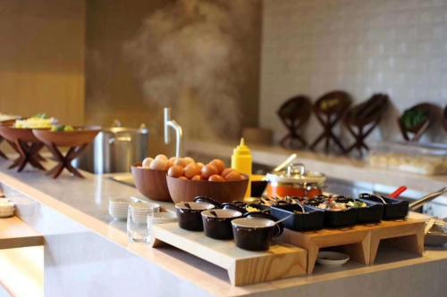 a buffet of food on a counter in a kitchen at EVEN Hotel Nanjing Yangtze River by IHG in Nanjing