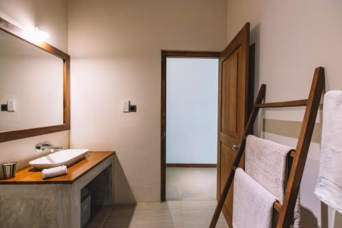 a bathroom with a sink and a mirror at Sevanagama in Habarana