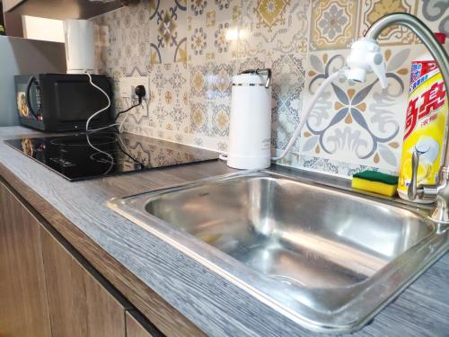 a kitchen counter with a sink in a kitchen at Parkview KLCC by Salaam Suites, 4 pax in Kuala Lumpur