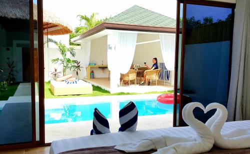 a bedroom with a view of a swimming pool at Montecarlo Villas Panglao in Panglao