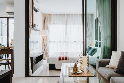 a hotel room with a bed and a living room at Siamplaengna Residence in Bangkok