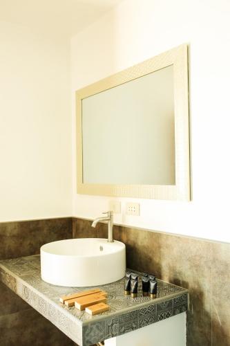 a bathroom with a sink and a mirror at Bali Villas Panglao Bohol in Panglao