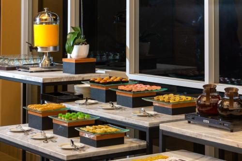 a buffet line with many different types of food at Hotel Santika Pasir Koja Bandung in Bandung