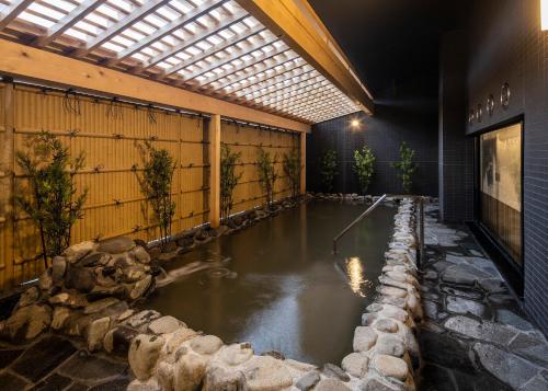 a pool of water in a room with a building at Hotel Route-Inn Wajima in Wajima