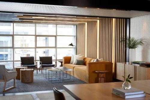 a living room with a couch and a table at Kimpton Hotel Wilshire by IHG in Los Angeles