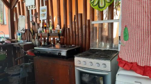 a kitchen with a stove and a counter with knives at Made Roejas Family in Uluwatu
