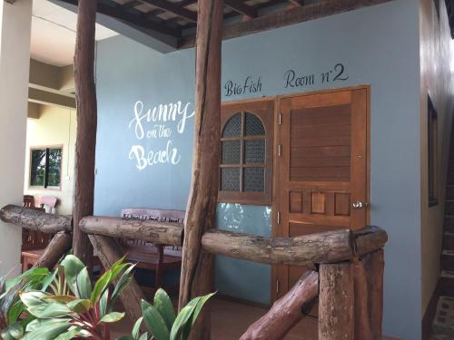 a entry to a resort with a wooden door at Big Fish Resort Koh Tao in Koh Tao
