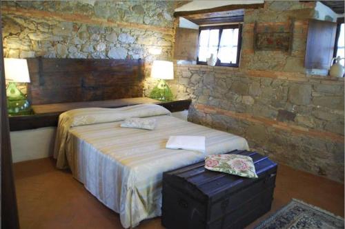 En eller flere senger på et rom på Villa Podere Isabella