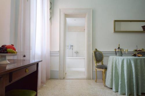 
a room with a table, a sink, and a door at Hotel Palazzo Vitturi in Venice
