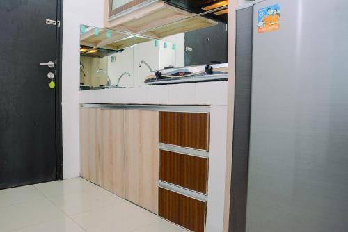 a kitchen with a sink and a counter top at 2BR Apartment at Park View Condominium near Universitas Indonesia By Travelio in Depok