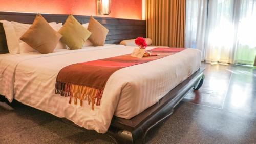 Postel nebo postele na pokoji v ubytování De Lanna Hotel