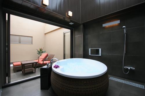 a bathroom with a large tub in a room at HOTEL W-PREMIUM -W GROUP HOTELS and RESORTS- in Koshigaya