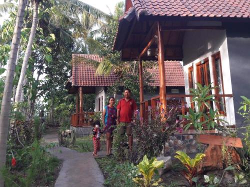a man and a woman standing in front of a house at Caga Garden in Nusa Penida