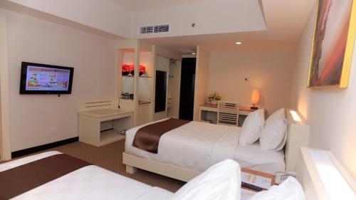 Postel nebo postele na pokoji v ubytování Beverly Hotel Batam
