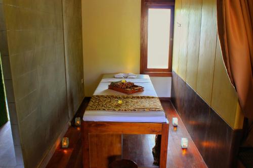 a small room with two beds and a window at The Batu Hotel & Villas in Batu