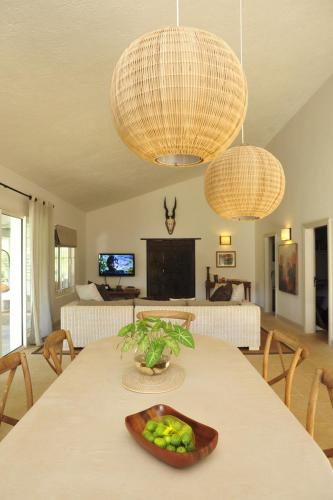 a room with a table with a bowl of fruit on it at Létan Lontan in Rodrigues Island