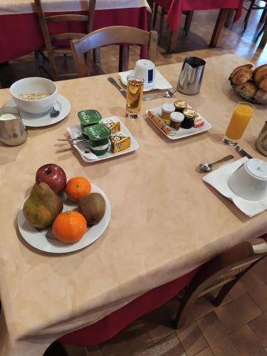 a wooden table with plates of food on it at L'Escale de Die in Die