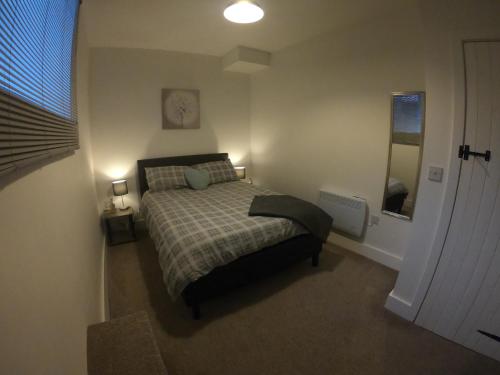 a small bedroom with a bed and a window at St Leonards cottage in Newark-on-Trent