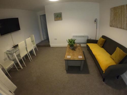 a living room with a couch and a table and chairs at St Leonards cottage in Newark upon Trent