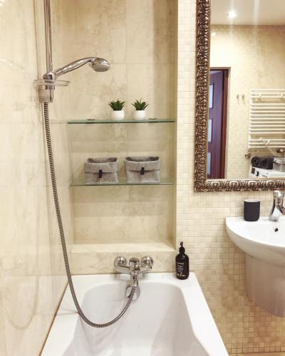 a bathroom with a shower and a sink and a tub at USTRONNE ZACISZE - Ustroń Zdrój Zeta Park in Ustroń