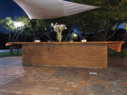 a brick wall with a white canopy over it at Villa Carolea in Acireale