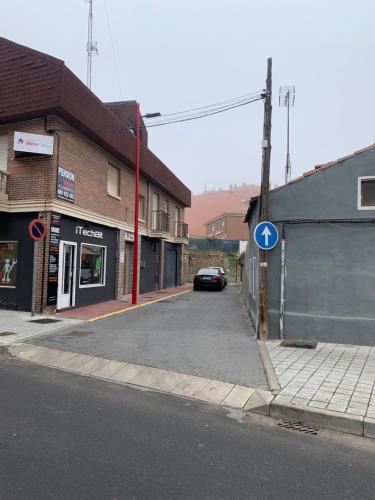 a street with a car parked on the side of the road at Alojamiento Weier in Valladolid