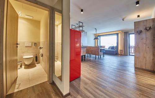 a room with a red door and a living room at THOMSN Central Hotel & Appartements in Saalbach Hinterglemm