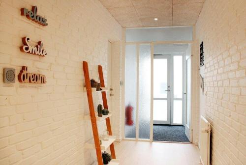 a hallway with a staircase in a room with a door at Nordkap Bed & Bath in Holstebro
