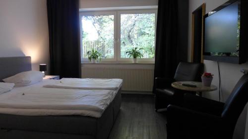 Un ou plusieurs lits dans un hébergement de l'établissement Hotel Heidpark