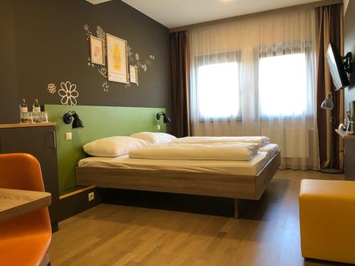 เตียงในห้องที่ JUFA Hotel Graz Süd