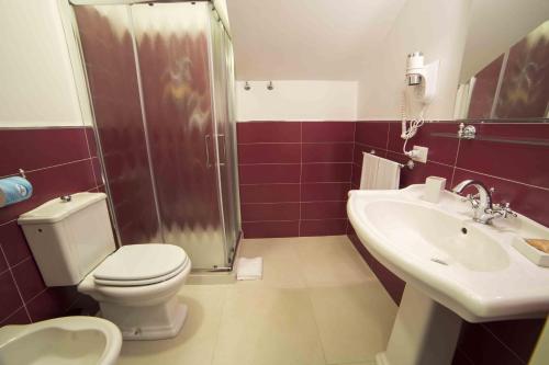 a bathroom with a toilet and a shower and a sink at Dimora De Mauro in Catania