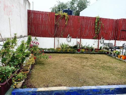 a garden with flowers and plants in front of a building at The Desire Hostel in New Delhi