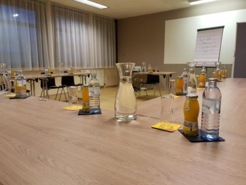 a conference room with bottles and glasses on a table at JUFA Hotel Graz Süd - Self Check-in in Graz