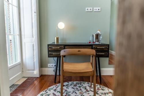 a desk with a chair in front of a room at 1905 Zino's Palace in Ponta do Sol