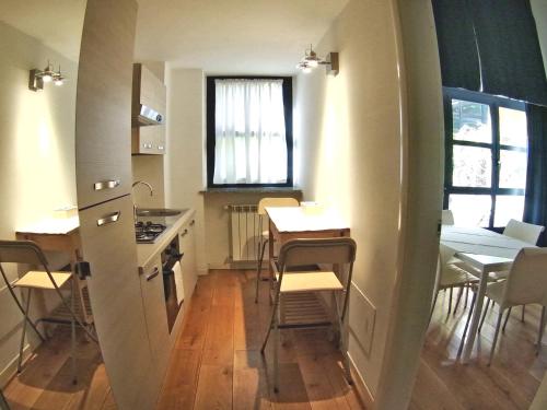 a small kitchen with a table and chairs and a table and a kitchen with at La Maison del Capestrano in Milan