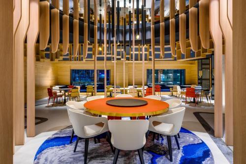 a dining room with a table and chairs at Hotel Indigo Taipei North by IHG in Taipei